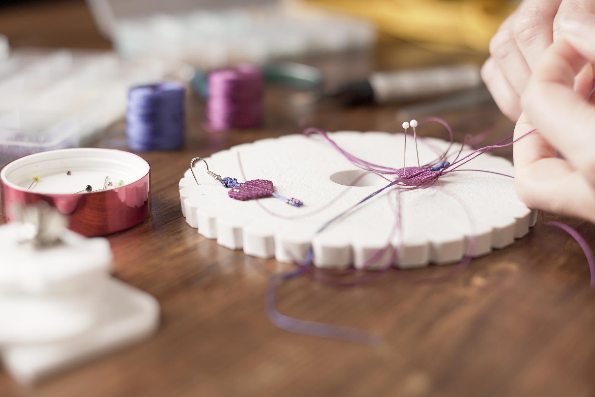 Workshop table with threads and embroidery hoop